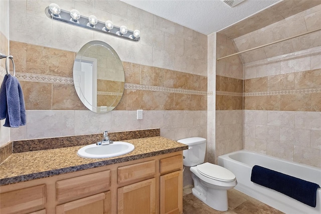 bathroom featuring toilet, a textured ceiling, tile walls, shower / bath combination, and vanity