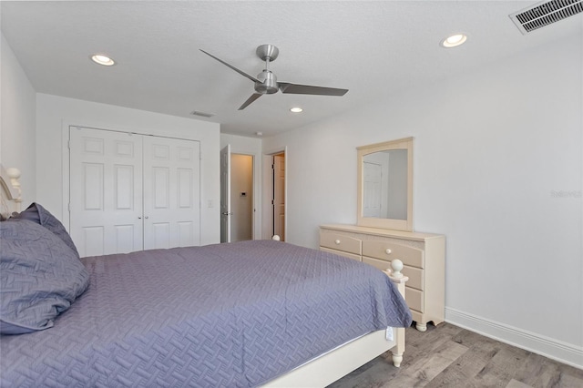 bedroom featuring recessed lighting, wood finished floors, and visible vents