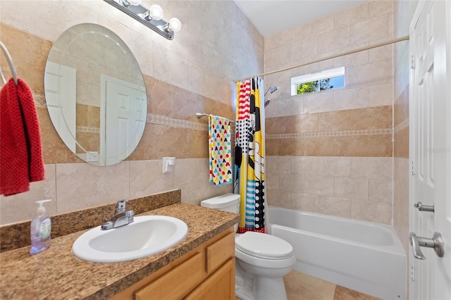 full bath with vanity, tile walls, shower / tub combo, and toilet