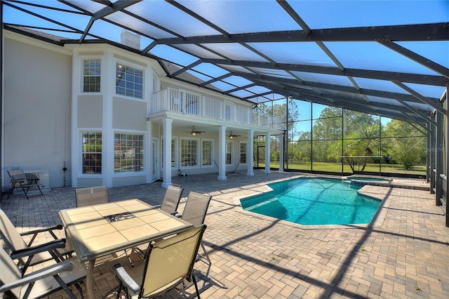 view of pool with outdoor dining space, a patio, and ceiling fan