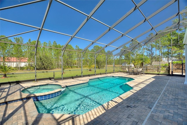 view of swimming pool with a lanai, a pool with connected hot tub, a patio, and fence