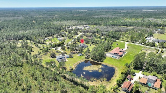 aerial view with a forest view and a water view