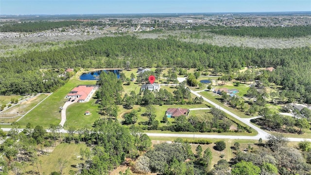 bird's eye view with a wooded view and a water view