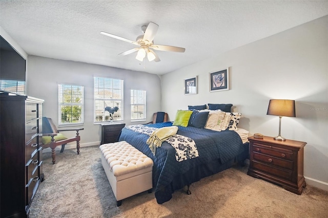 bedroom featuring baseboards, carpet floors, and a textured ceiling