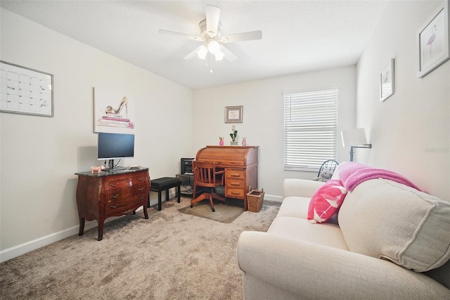 office featuring baseboards, light colored carpet, and ceiling fan