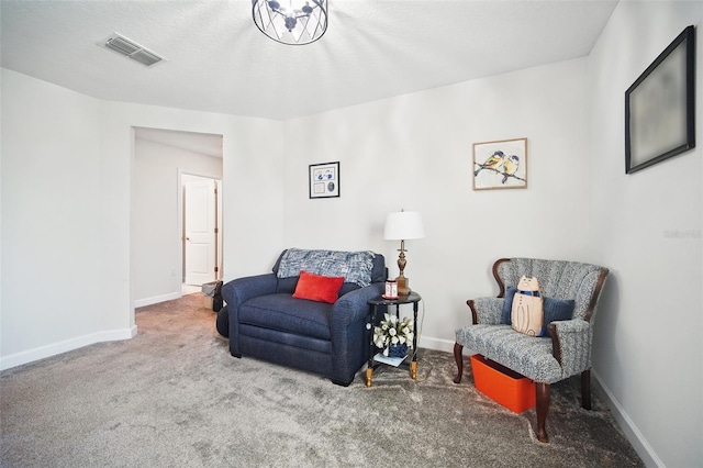 sitting room with visible vents, baseboards, and carpet floors