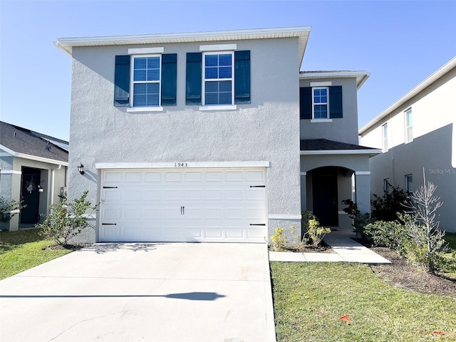 traditional-style house featuring stucco siding, concrete driveway, and an attached garage