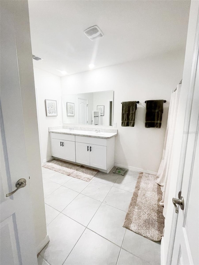 full bath featuring tile patterned floors, visible vents, a sink, and double vanity