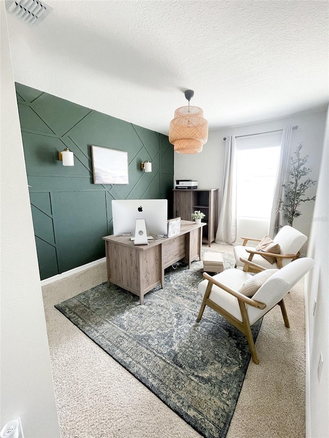 interior space featuring baseboards, visible vents, and a textured ceiling