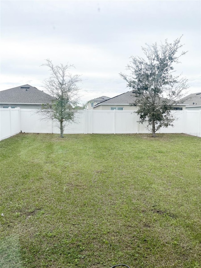 view of yard with a fenced backyard