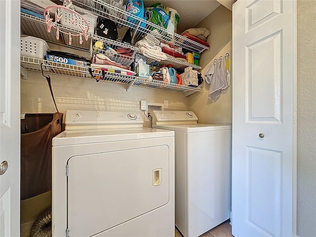 washroom with laundry area and washing machine and dryer