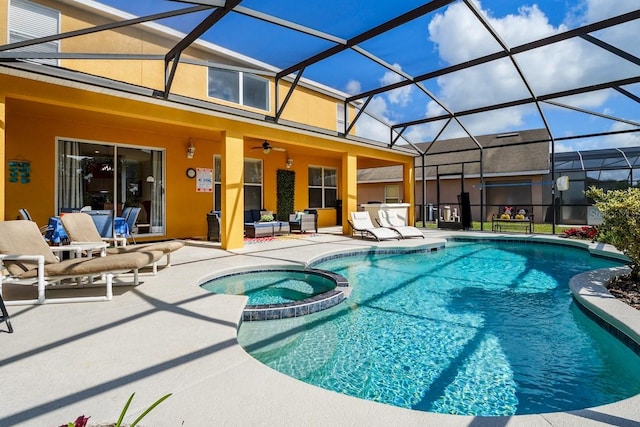 view of pool featuring glass enclosure, an outdoor living space, a pool with connected hot tub, ceiling fan, and a patio area