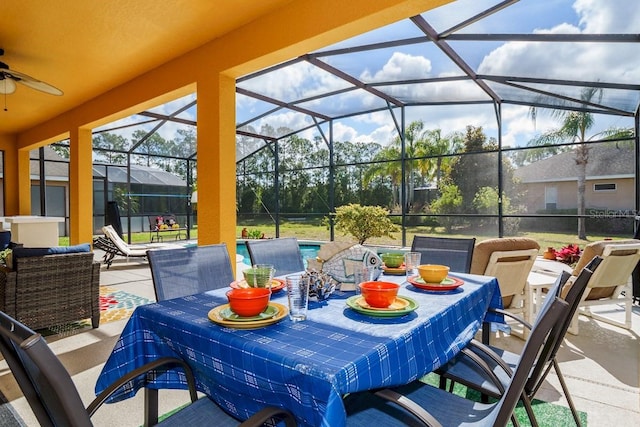 view of patio / terrace with outdoor dining space, glass enclosure, an outdoor pool, and a ceiling fan