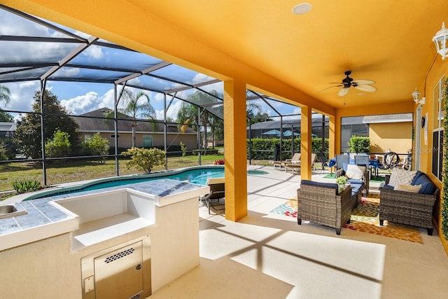 view of patio / terrace featuring a lanai, an outdoor pool, outdoor lounge area, and ceiling fan