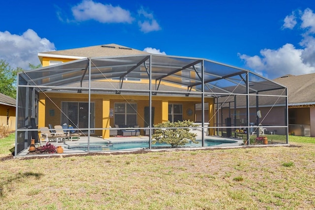 back of house featuring a patio area, a lawn, an outdoor pool, and stucco siding