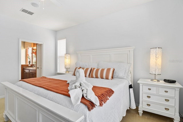 bedroom with visible vents, ensuite bathroom, ceiling fan, and a sink