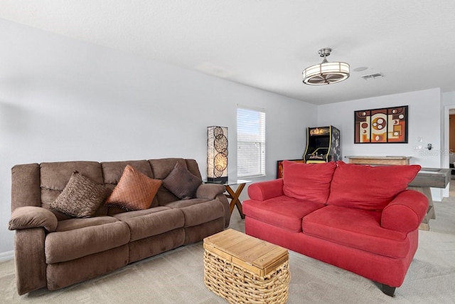 living area featuring visible vents and light carpet