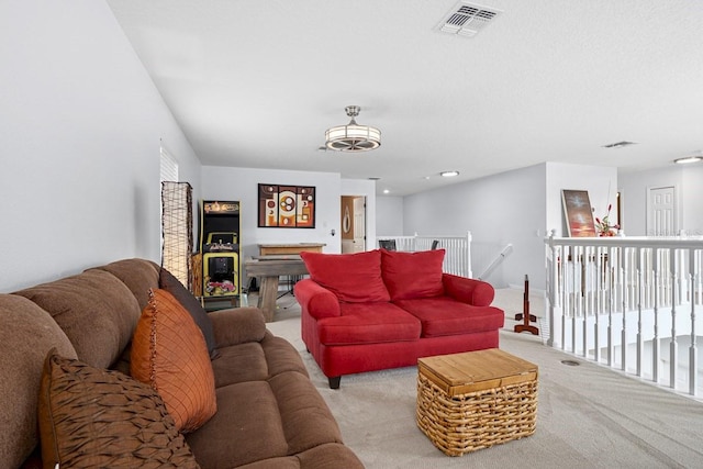 living area featuring visible vents and carpet