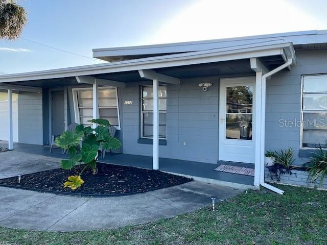 view of exterior entry with covered porch