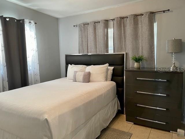 bedroom with light tile patterned floors