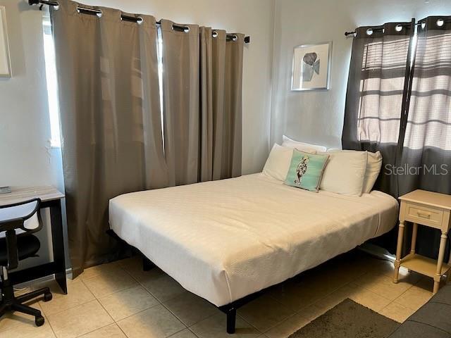 bedroom with light tile patterned flooring