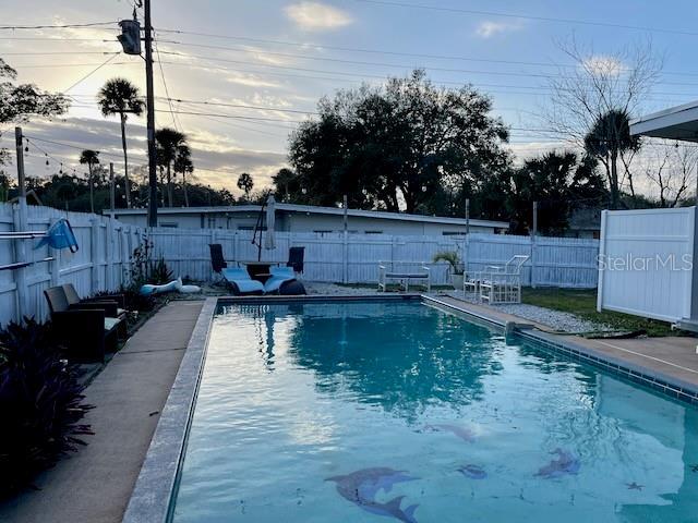 view of swimming pool featuring a fenced backyard and a fenced in pool