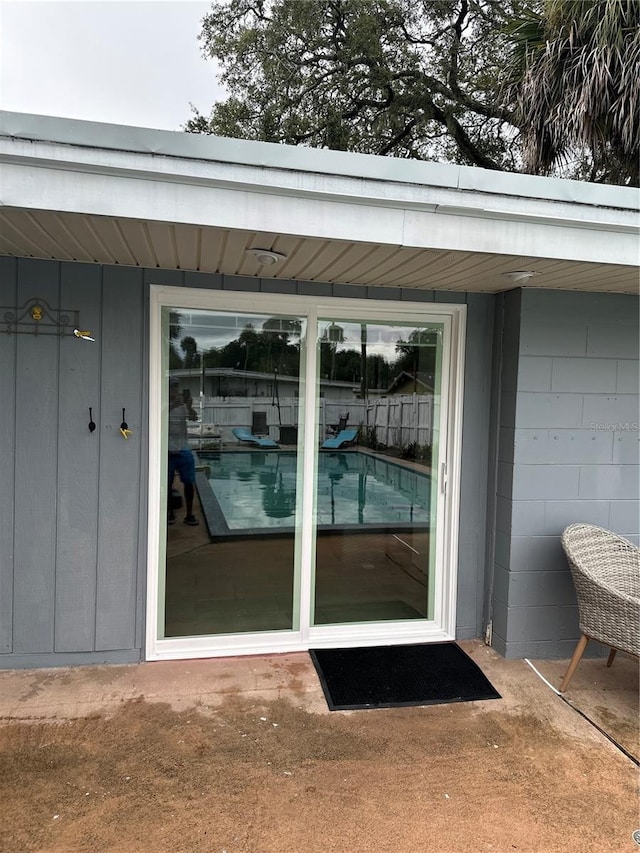 doorway to property with concrete block siding