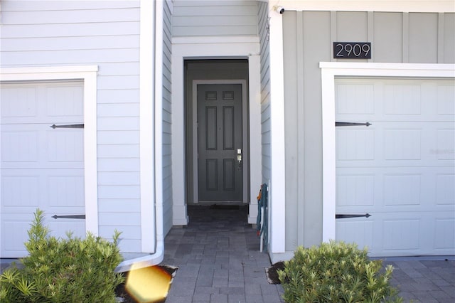 doorway to property with a garage