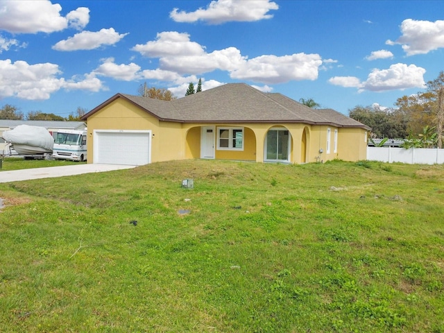 ranch-style house featuring fence, concrete driveway, a front yard, stucco siding, and a garage