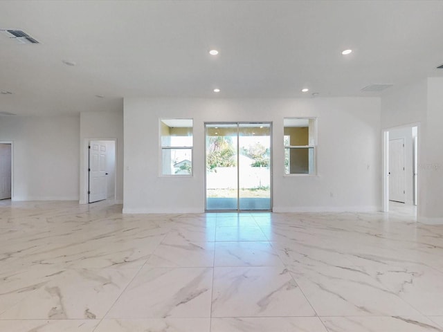 spare room with recessed lighting, visible vents, baseboards, and marble finish floor