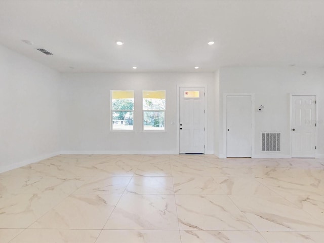 unfurnished room with recessed lighting, visible vents, baseboards, and marble finish floor