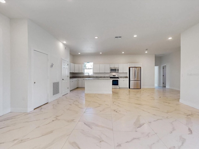 kitchen featuring recessed lighting, marble finish floor, visible vents, and appliances with stainless steel finishes