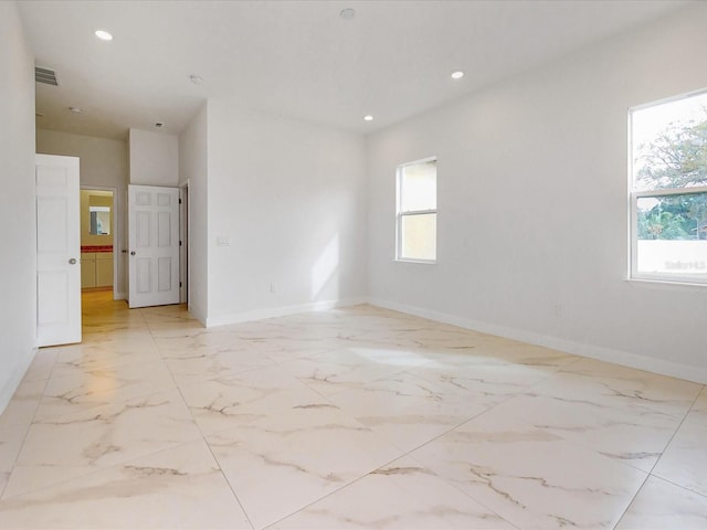 spare room with visible vents, recessed lighting, marble finish floor, and baseboards