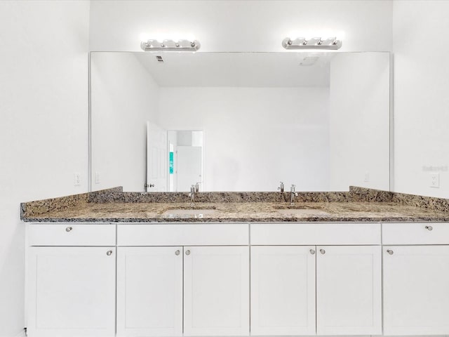 bathroom featuring double vanity and a sink