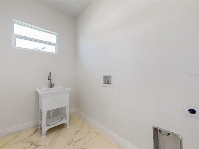 clothes washing area featuring laundry area, marble finish floor, baseboards, and washer hookup