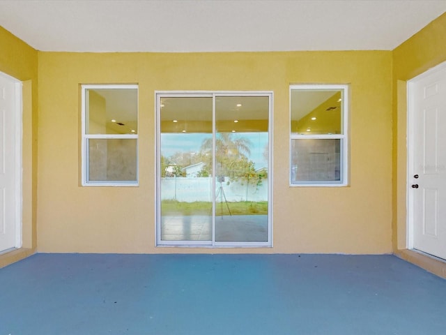 doorway to property with stucco siding and a patio area