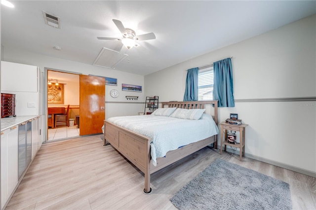 bedroom featuring visible vents, connected bathroom, baseboards, light wood-type flooring, and a ceiling fan