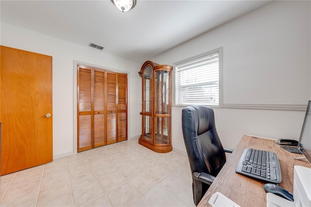 office space featuring light tile patterned flooring, baseboards, and visible vents