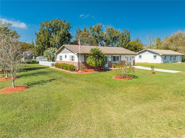 ranch-style house featuring a front yard and driveway