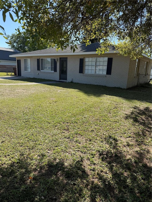 ranch-style home with a front lawn and brick siding