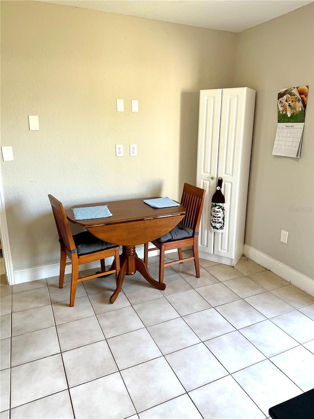 dining room with baseboards and light tile patterned flooring