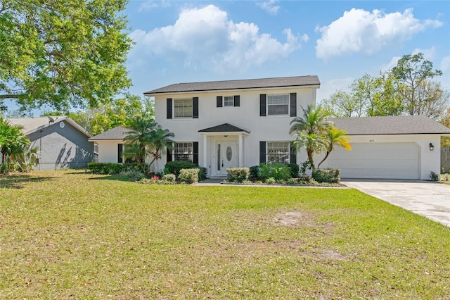 colonial inspired home with a garage, a front lawn, driveway, and stucco siding