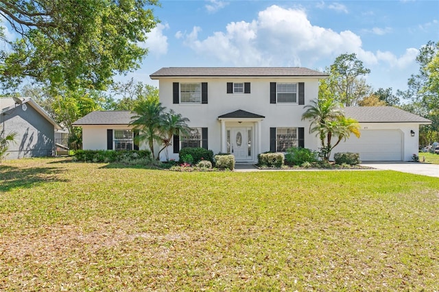 colonial house with a front lawn, an attached garage, driveway, and stucco siding