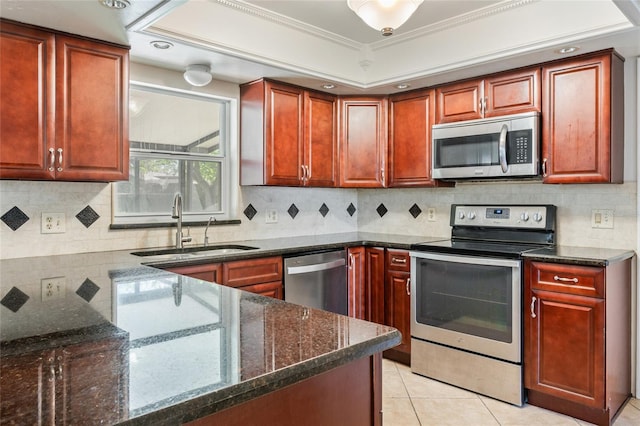 kitchen featuring a sink, dark stone countertops, backsplash, stainless steel appliances, and light tile patterned floors