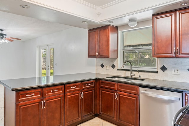 kitchen with backsplash, dark brown cabinets, a peninsula, stainless steel dishwasher, and a sink