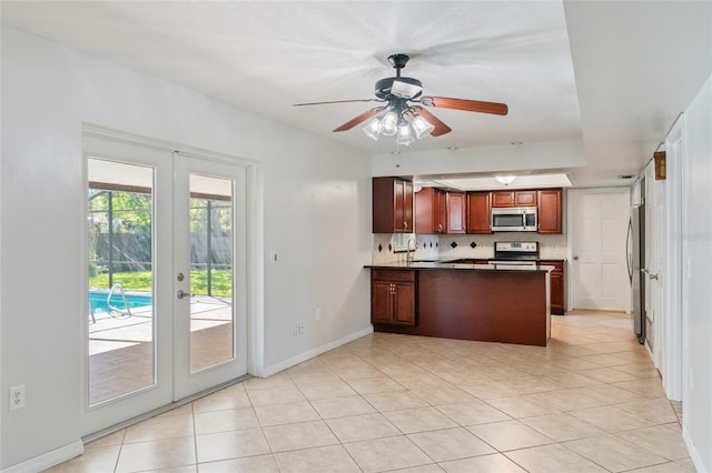 kitchen featuring tasteful backsplash, baseboards, french doors, a peninsula, and stainless steel appliances