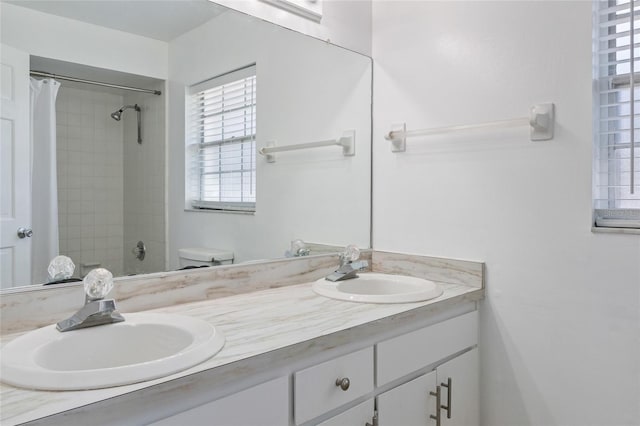 full bath featuring double vanity, toilet, and a sink