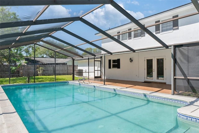 view of pool with a fenced in pool, french doors, glass enclosure, and fence