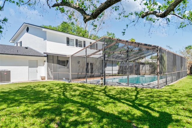 view of pool with cooling unit, a yard, a fenced in pool, and glass enclosure