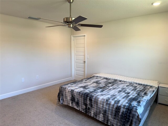 bedroom featuring visible vents, ceiling fan, baseboards, a textured ceiling, and dark colored carpet